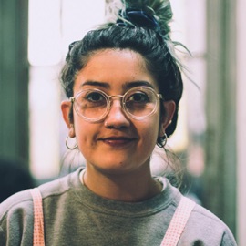 Picture of a lady in cool hip glasses.